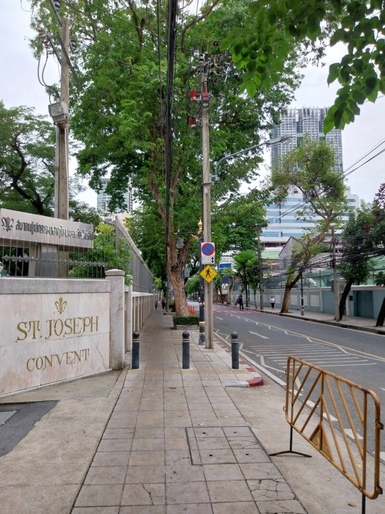 Opposite the school