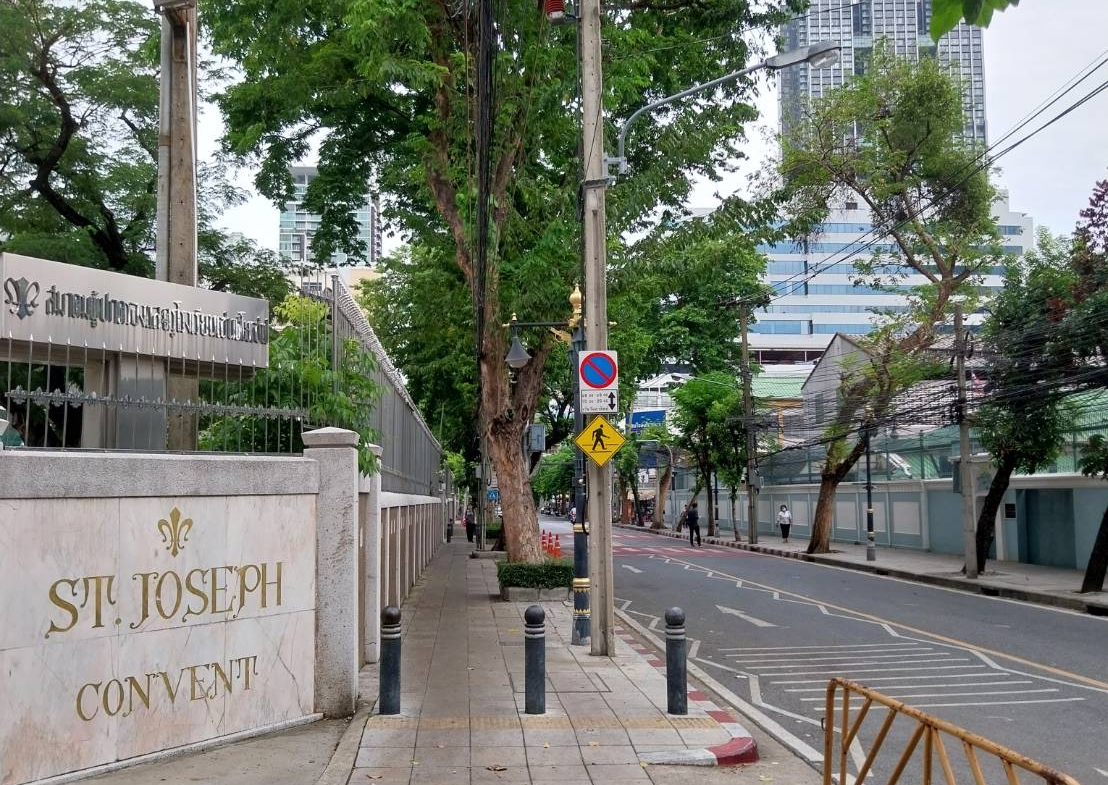 Opposite the school